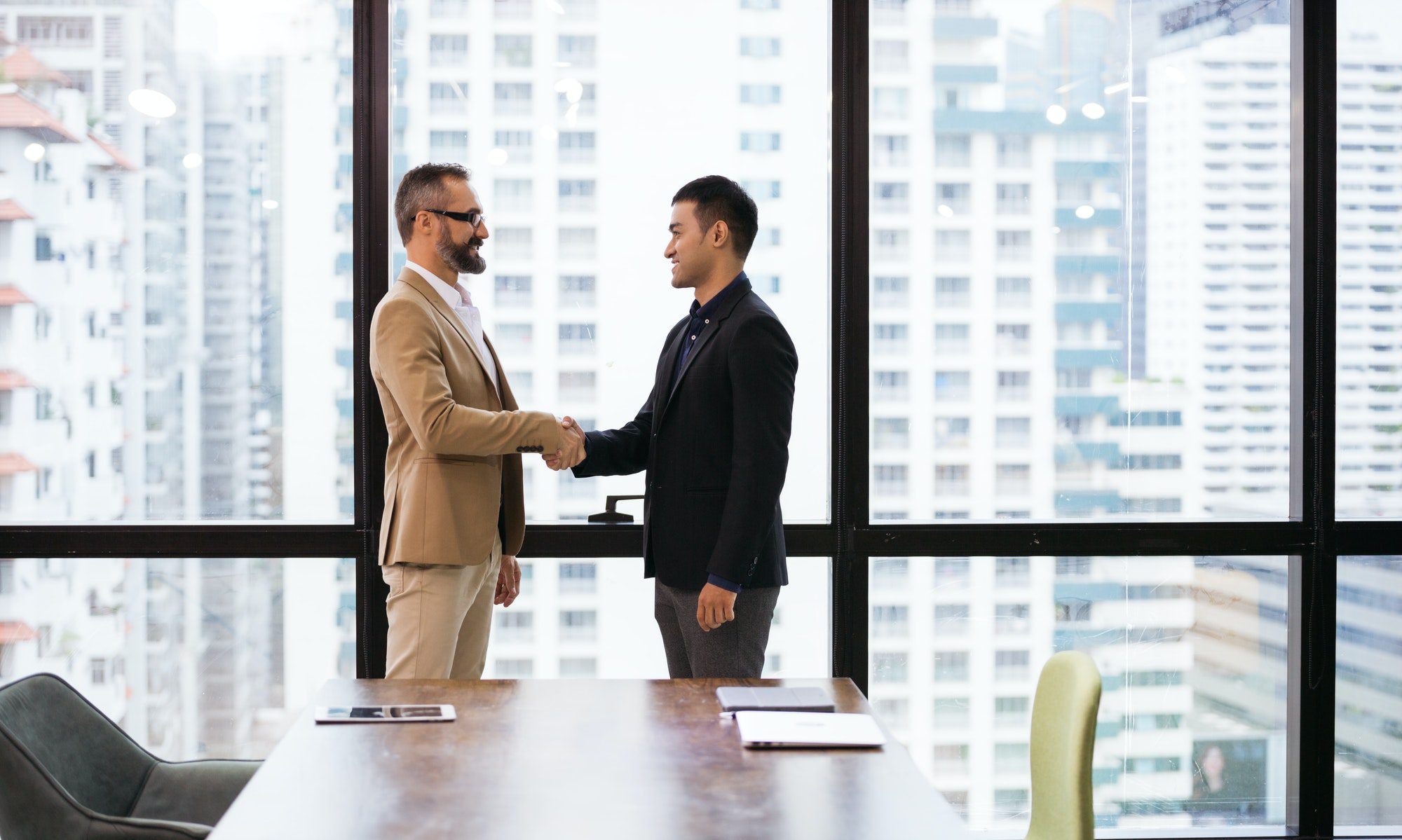 Caucasian business man handshaking with company partner or customer