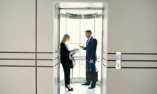 Business people standing in elevator Business people standing in elevator