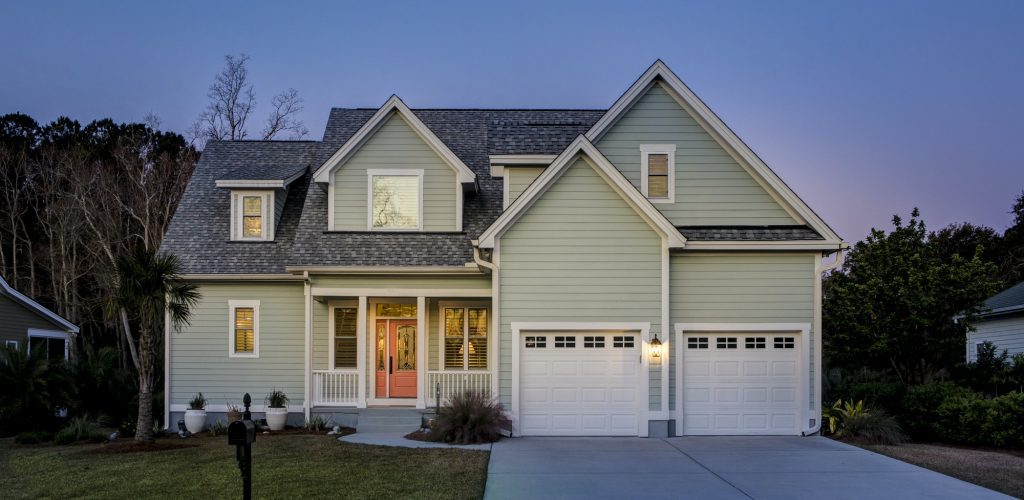 Front elevation of beautiful home lit up at twilight. Front elevation of beautiful home lit up at twilight.