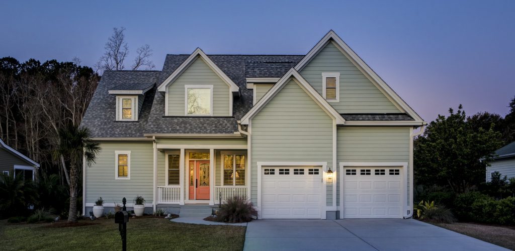 Front elevation of beautiful home lit up at twilight.